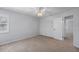 Bedroom features neutral carpet, ceiling fan, and closet at 902 Marco Ne Dr, St Petersburg, FL 33702