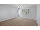 Bright bedroom with neutral carpet, ceiling fan, and shuttered windows at 902 Marco Ne Dr, St Petersburg, FL 33702