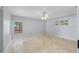 Bright bedroom featuring neutral carpet and shuttered windows at 902 Marco Ne Dr, St Petersburg, FL 33702