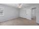 Bright bedroom with neutral carpet, ceiling fan, and closet at 902 Marco Ne Dr, St Petersburg, FL 33702