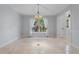 Bright dining room featuring wainscoting, tile floors, and a charming chandelier at 902 Marco Ne Dr, St Petersburg, FL 33702