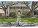 Charming two-story home with mature trees, manicured lawn, and neatly trimmed shrubs at 902 Marco Ne Dr, St Petersburg, FL 33702