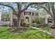 Stately two-story home with manicured lawn, mature trees, and classic architectural details at 902 Marco Ne Dr, St Petersburg, FL 33702