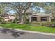 Charming home with well-manicured lawn, mature trees, and lush landscaping at 902 Marco Ne Dr, St Petersburg, FL 33702