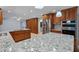 Gourmet kitchen with double islands, stainless steel appliances, and custom cabinets at 902 Marco Ne Dr, St Petersburg, FL 33702