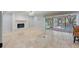 Bright, open living room with fireplace and access to a screened-in pool area at 902 Marco Ne Dr, St Petersburg, FL 33702