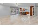 Open concept living space with travertine floors and views of the lanai and pool at 902 Marco Ne Dr, St Petersburg, FL 33702