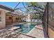 A screened-in pool features a brick surround and attached covered lanai at 902 Marco Ne Dr, St Petersburg, FL 33702