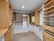 Large walk-in closet with custom wood shelving and drawers for maximum storage at 902 Marco Ne Dr, St Petersburg, FL 33702