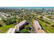 Overhead view of condo buildings surrounded by mature trees and green spaces, showcasing the tranquil setting at 9433 Harbor Greens Way # 405, Seminole, FL 33776