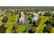 Overhead view of condominium buildings, swimming pool, lake, and palm trees in a sunny location at 9433 Harbor Greens Way # 405, Seminole, FL 33776