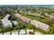 Beautiful aerial view of waterfront condos with a community pool and lush landscaping in a desirable location at 9433 Harbor Greens Way # 405, Seminole, FL 33776
