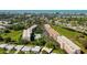 Beautiful aerial view of condo community, featuring lush landscaping and a sparkling community pool at 9433 Harbor Greens Way # 405, Seminole, FL 33776