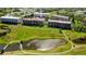 Community grounds with lake, walking path, and palm trees. The condo buildings feature multiple units at 9433 Harbor Greens Way # 405, Seminole, FL 33776