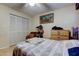 Cozy bedroom featuring neutral walls, ceiling fan, and a comfortable bed with striped bedding at 9433 Harbor Greens Way # 405, Seminole, FL 33776