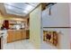 Kitchen featuring a view into dining area, light wood cabinetry, neutral countertops, and white refrigerator at 9433 Harbor Greens Way # 405, Seminole, FL 33776