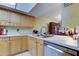 Kitchen showcasing stainless steel dishwasher, light cabinetry, and neutral countertops at 9433 Harbor Greens Way # 405, Seminole, FL 33776