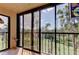 Enclosed lanai with screened windows offering expansive views of lush green surroundings at 9433 Harbor Greens Way # 405, Seminole, FL 33776
