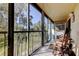 Relaxing screened lanai featuring a rocking chair, providing a peaceful outdoor living space at 9433 Harbor Greens Way # 405, Seminole, FL 33776