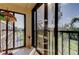Bright lanai with large windows offering panoramic views of green landscape and plenty of natural light at 9433 Harbor Greens Way # 405, Seminole, FL 33776