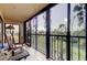 Relaxing screened lanai with comfortable rocking chair, offering serene views and peaceful ambiance at 9433 Harbor Greens Way # 405, Seminole, FL 33776