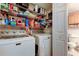 Laundry room providing a washer, dryer and shelving for storing all your cleaning supplies at 9433 Harbor Greens Way # 405, Seminole, FL 33776