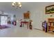 Bright living room featuring neutral tile flooring and access to a balcony, perfect for relaxing at 9433 Harbor Greens Way # 405, Seminole, FL 33776