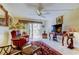 Cozy living room featuring a ceiling fan, tile floors, and sliding glass doors that open to the balcony at 9433 Harbor Greens Way # 405, Seminole, FL 33776