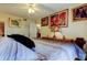 Comfortable main bedroom with ceiling fan, bedside table and artwork adorning the walls at 9433 Harbor Greens Way # 405, Seminole, FL 33776