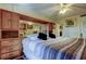 Comfortable main bedroom featuring a king bed, ceiling fan, and built-in wall storage and mirror at 9433 Harbor Greens Way # 405, Seminole, FL 33776