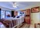 Comfortable main bedroom featuring a king bed, ceiling fan, balcony access, and built-in wall storage at 9433 Harbor Greens Way # 405, Seminole, FL 33776