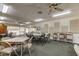 Community center meeting room featuring neutral decor, tables, folding chairs, and updated ceiling lighting at 9433 Harbor Greens Way # 405, Seminole, FL 33776