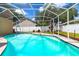 Screened-in pool with clear water and surrounding greenery at 9608 Norchester Cir, Tampa, FL 33647