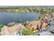 Scenic aerial view of the condo community with a large lake and lush landscaping, showing 9730 and the garage at 9730 Lake Chase Island Way # 9730, Tampa, FL 33626