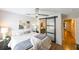 Bedroom with a sliding barn door leading to the ensuite bathroom, with hardwood floors and neutral walls at 9730 Lake Chase Island Way # 9730, Tampa, FL 33626