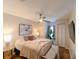 Bedroom featuring hardwood floors, ceiling fan and neutral walls with closet space at 9730 Lake Chase Island Way # 9730, Tampa, FL 33626