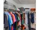 Walk-in closet featuring ample shelving and hanging space for organized storage at 9730 Lake Chase Island Way # 9730, Tampa, FL 33626