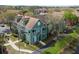 An eye-level exterior view of a green two-story condo with a small balcony and sliding glass doors at 9730 Lake Chase Island Way # 9730, Tampa, FL 33626