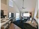 Living room featuring vaulted ceilings, modern furniture, and access to a balcony with water views at 9730 Lake Chase Island Way # 9730, Tampa, FL 33626