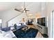 Open-concept living space with vaulted ceilings, modern decor, and seamless flow to the dining area at 9730 Lake Chase Island Way # 9730, Tampa, FL 33626