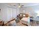 Living room featuring a ceiling fan, hardwood floors and neutral walls with white trim at 9730 Lake Chase Island Way # 9730, Tampa, FL 33626