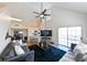 Bright living room with vaulted ceilings, a ceiling fan, and a sliding glass door to a balcony at 9730 Lake Chase Island Way # 9730, Tampa, FL 33626