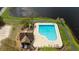 Aerial shot of community kidney bean shaped pool and surrounding area, with lush landscaping at 9730 Lake Chase Island Way # 9730, Tampa, FL 33626