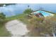 Scenic aerial view of community pool and beach volleyball, close to lake at 9730 Lake Chase Island Way # 9730, Tampa, FL 33626