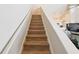 Staircase with wooden steps leading to a living area and kitchen at 9730 Lake Chase Island Way # 9730, Tampa, FL 33626