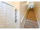 Carpeted staircase near a coat rack and storage area at 9730 Lake Chase Island Way # 9730, Tampa, FL 33626