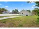 Backyard and side view of a home, highlighting the green lawn and ample space at 1001 Newton S Ave, St Petersburg, FL 33705