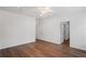 A bright bedroom features hardwood floors, white walls and trim, and a ceiling fan with light at 1001 Newton S Ave, St Petersburg, FL 33705