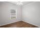Bedroom with hardwood floors, white walls and trim, a ceiling fan with light and a window with blinds at 1001 Newton S Ave, St Petersburg, FL 33705
