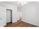 Bedroom with hardwood floors, white walls and trim, and an open closet at 1001 Newton S Ave, St Petersburg, FL 33705